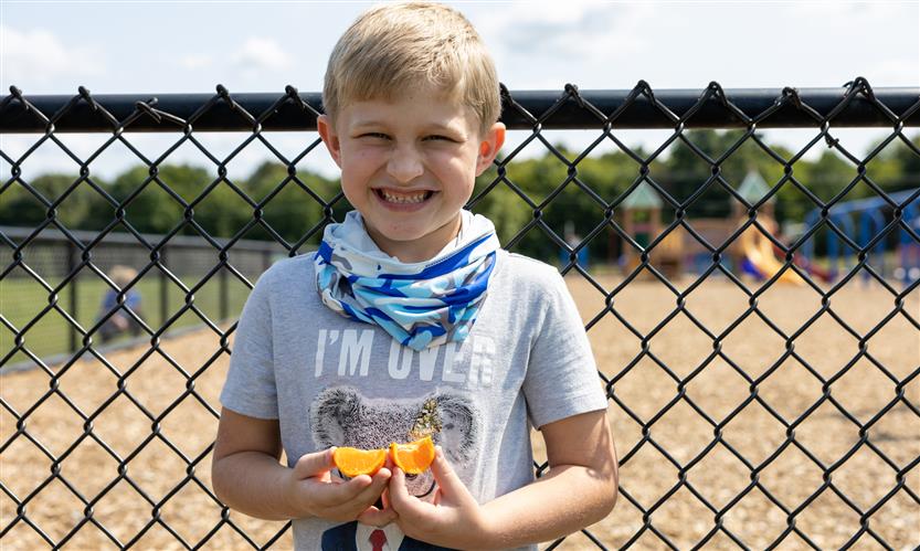 Students smile while releasing butterflies outside